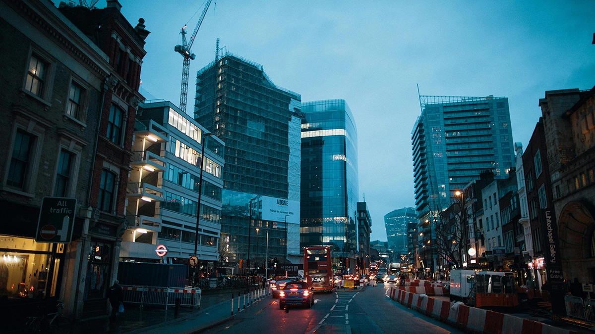 Night time view of Aldgate Station taken on Aldgate High Street looking towards the City of London