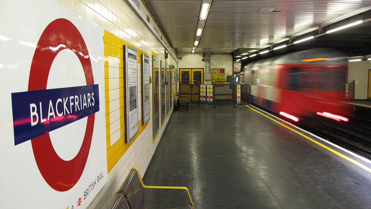 A tube train departs Blackfriars station