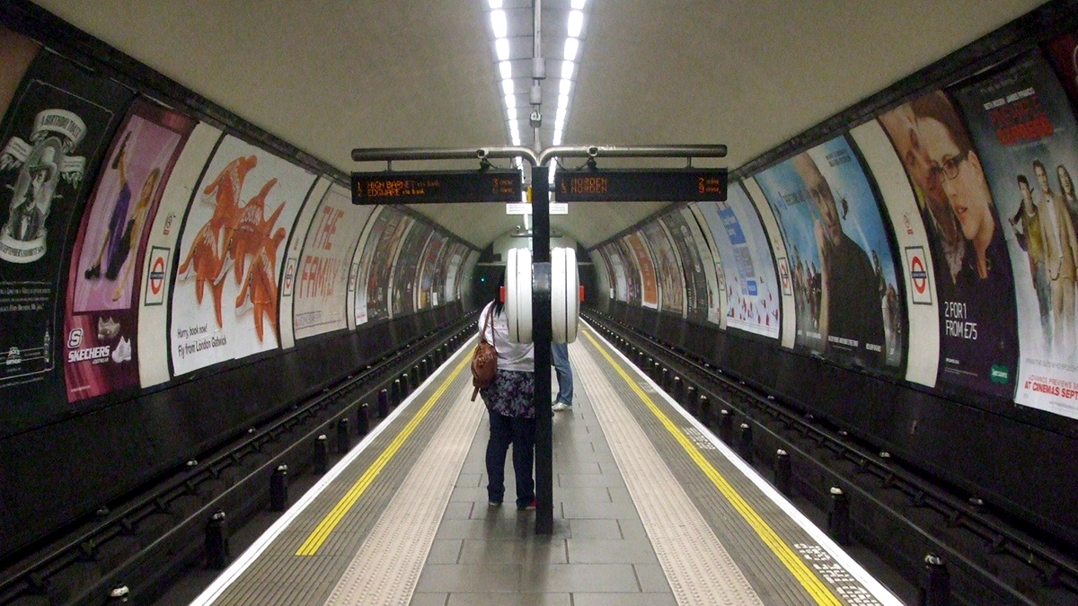 Cross track adverts dominating the double platform at Clapham Common Station