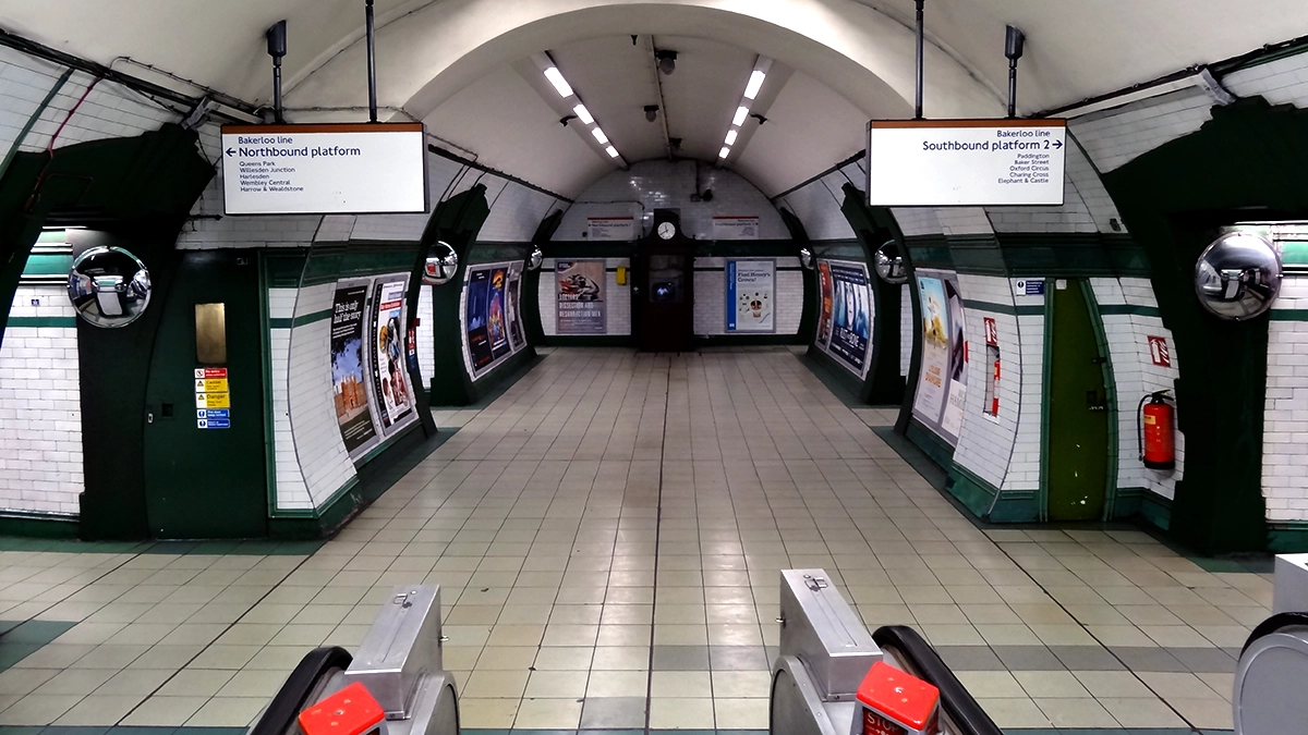 The Bakerloo line corridor with adverts at Kilburn Park tube station