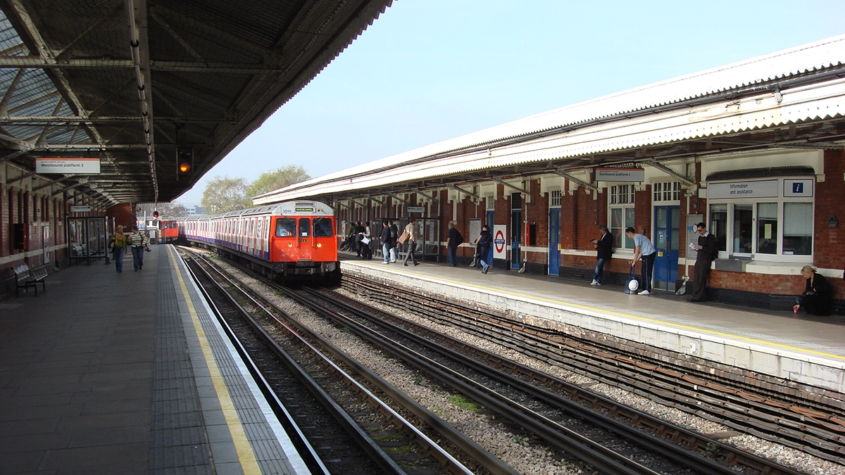 Commuters wait for their trains at the platform at Ladbroke Grove station
