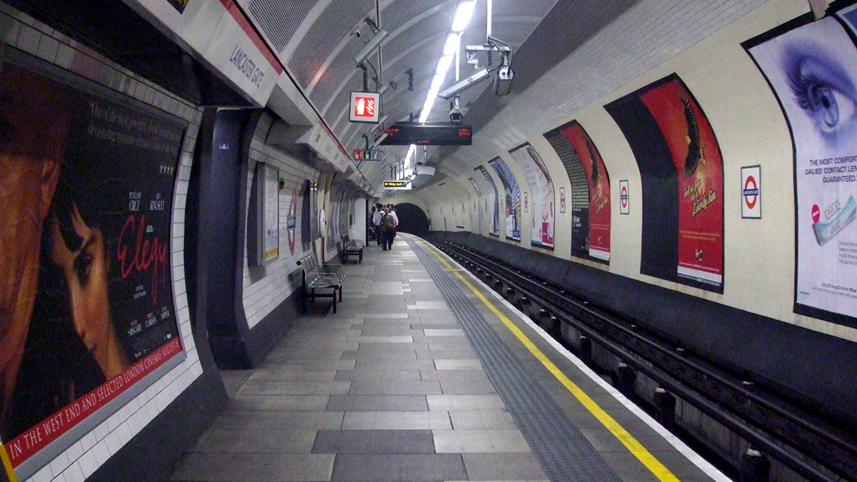 Platform and cross track advert posters at Lancaster Gate station