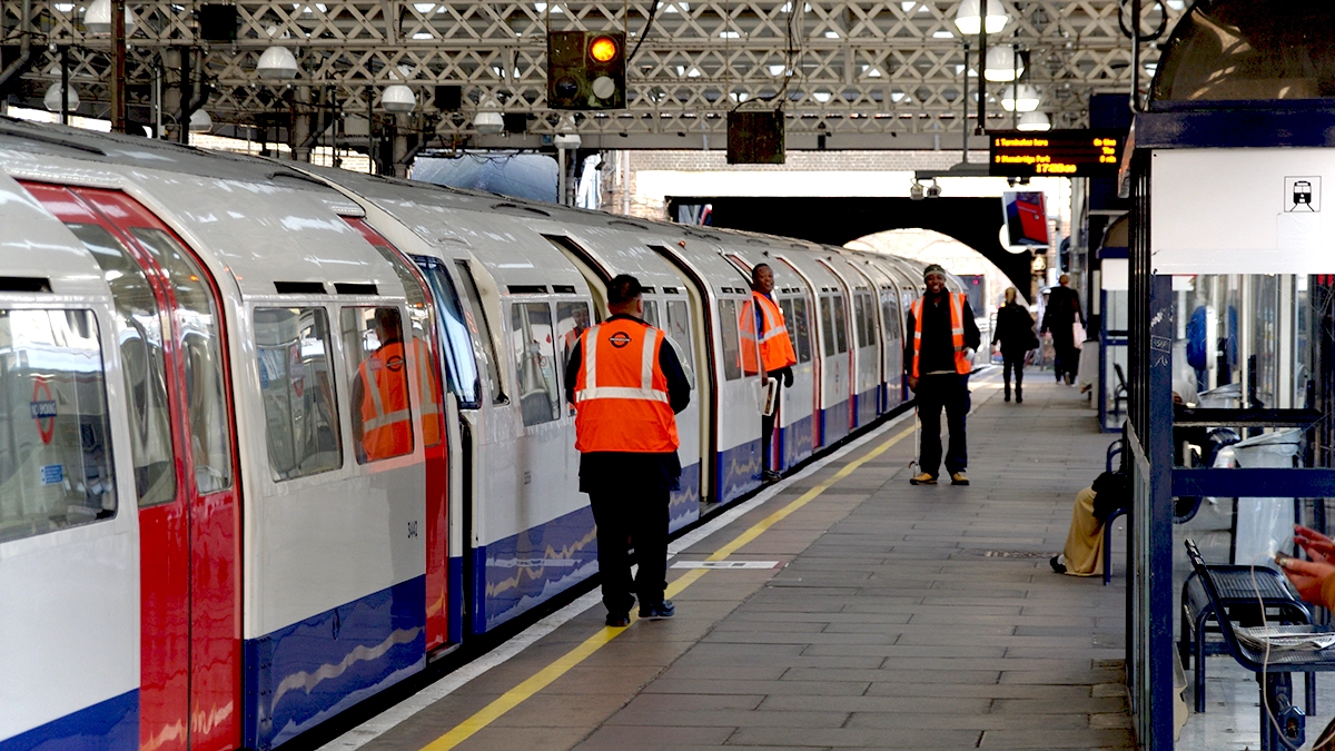 TfL staff check a tube train at Queen's Park station