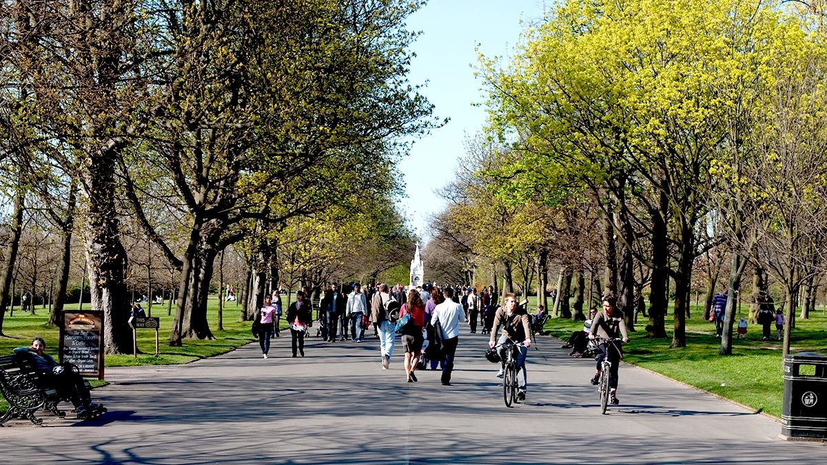 Regent's Park filled with cyclists and visitors on a sunny day