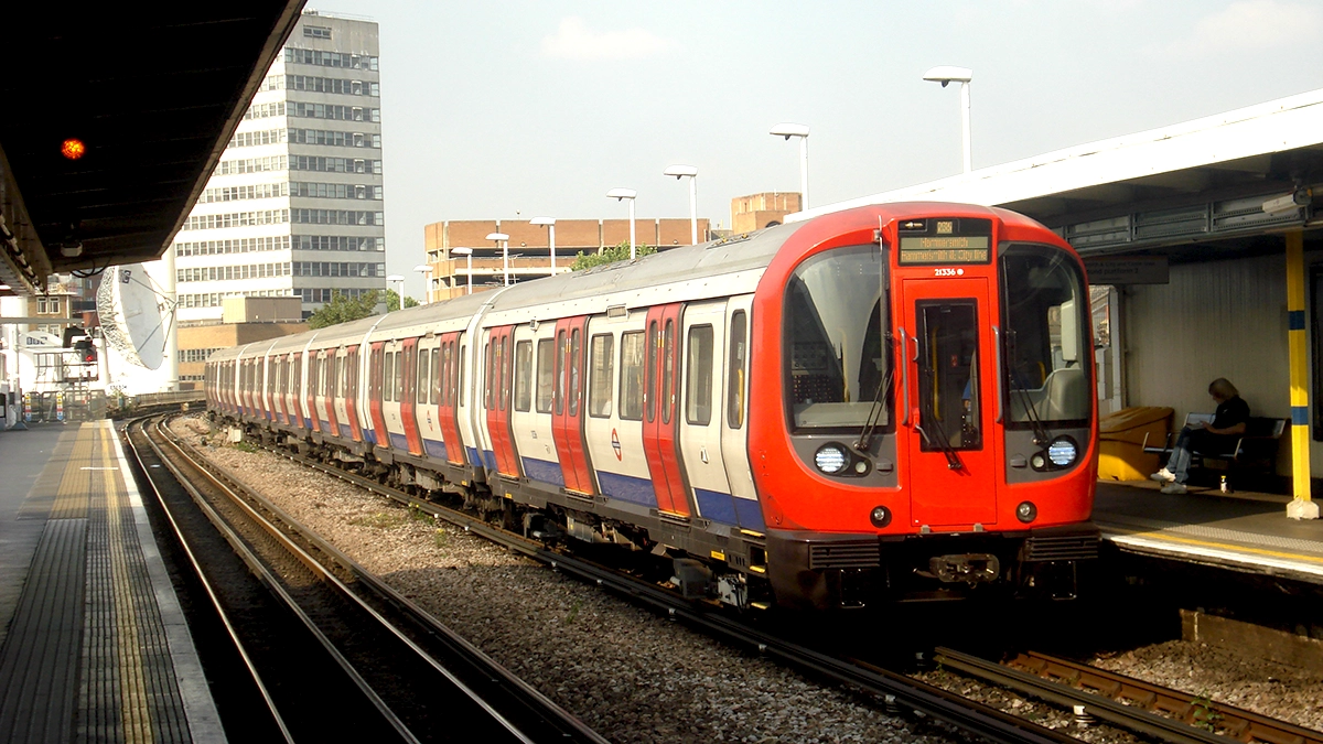 A train pulls into the surface level platforms at Shepherd's Bush Market tube station