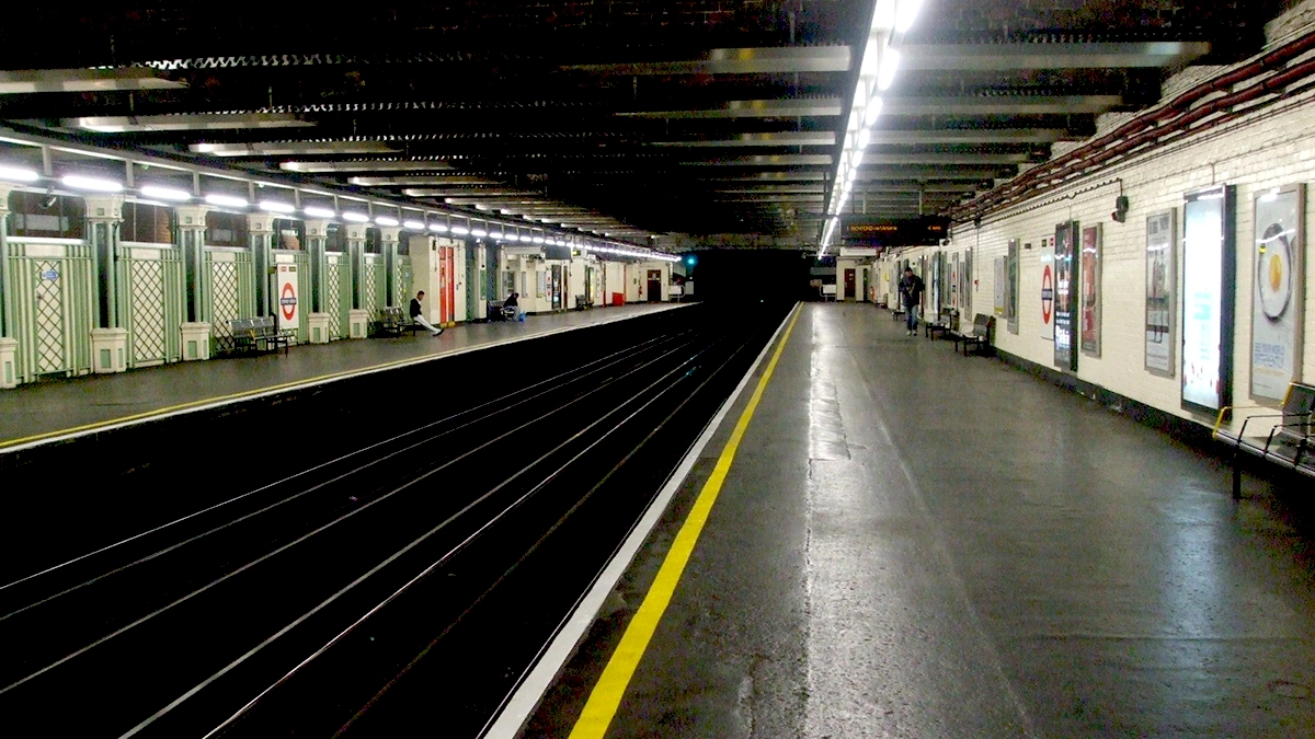 Platform adverts next to the tracks at Stepney Green tube station