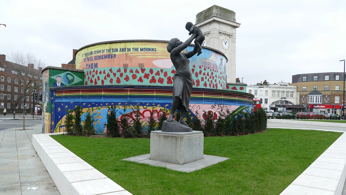 A decorated deep level shelter and bronze statue act as a memorial at Stockwell tube station