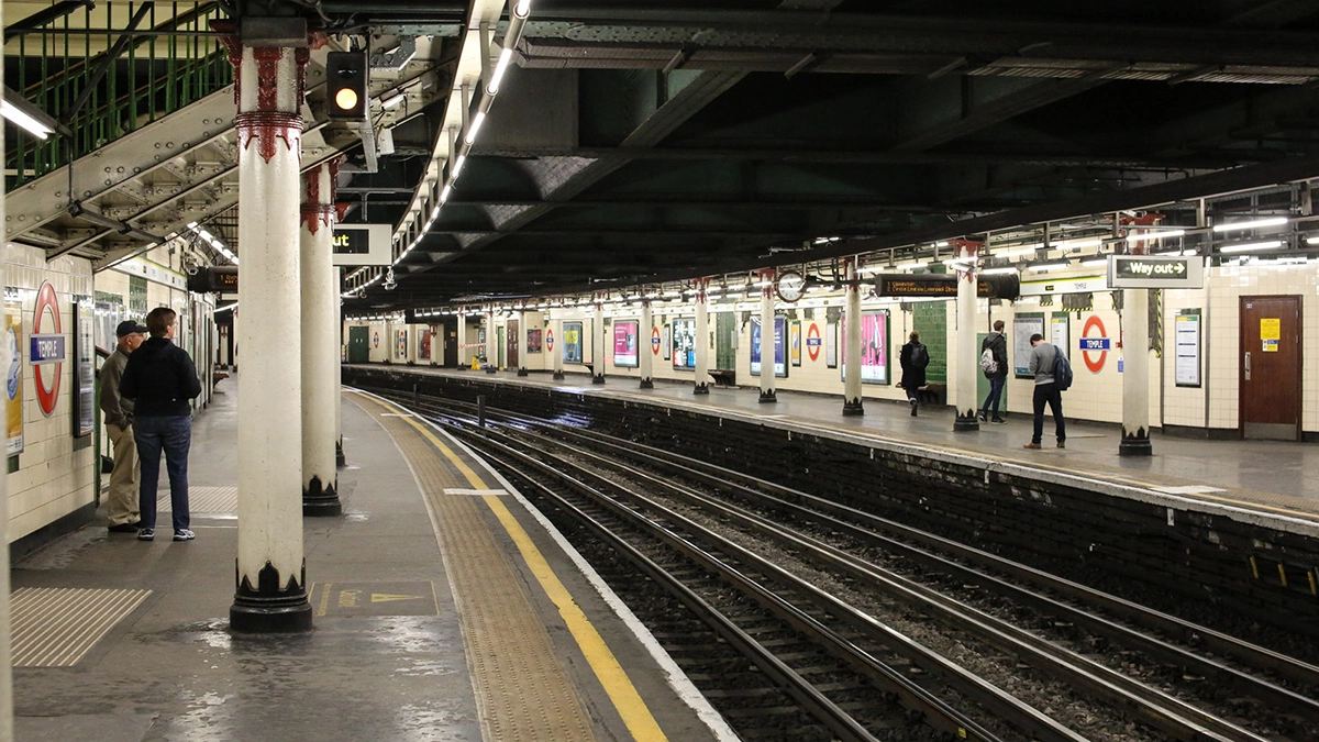A view across the tracks at Temple station with platform level adverts lining the walls