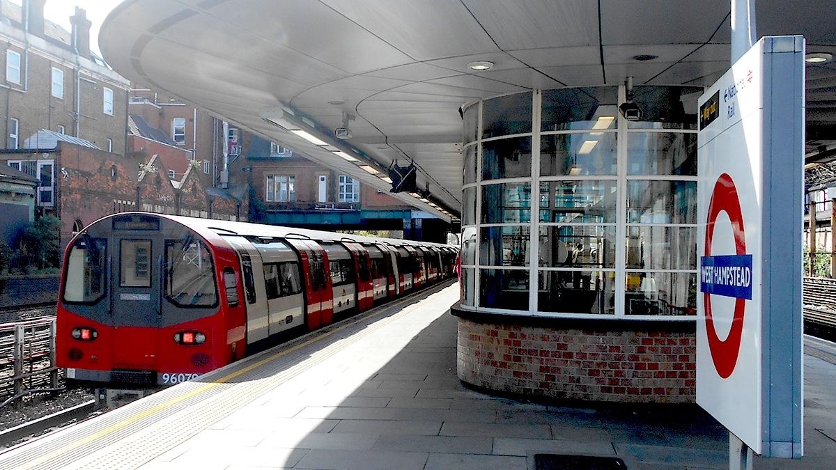 A tube train arrives into the platform at West Hampstead station